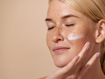woman applying moisturiser