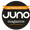 An orange and dark brown circular badge stating that Self Tan Lotion 150ml was featured in Juno magazine.