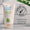 A white tube of Organic Babies Baby Wash & Shampoo Scent Free sits beside a Dermatologically Tested logo against a white tiled wall.