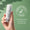 A hand holds a bottle of Green People Scent Free Face & Neck Serum against a green background featuring a Dermatologically Tested logo.