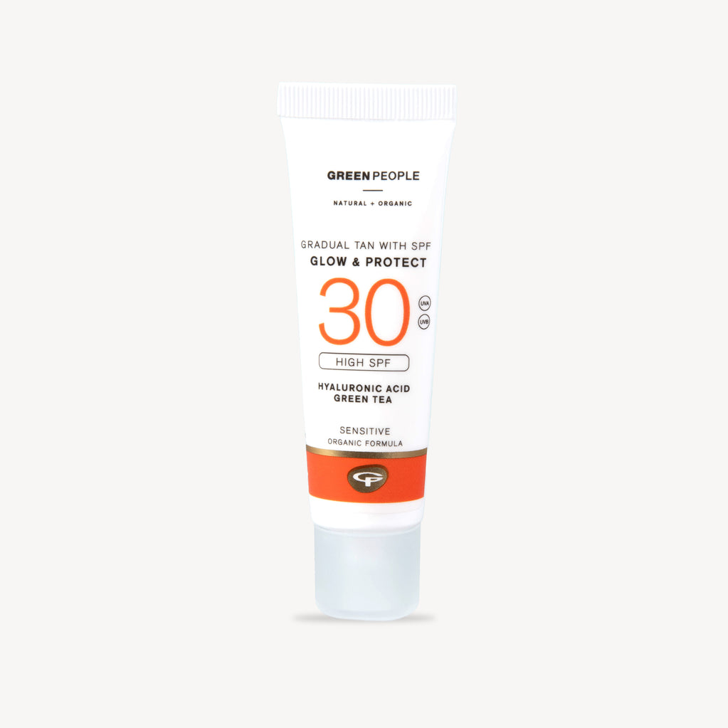 White tube of gradual tan with SPF 30 featuring orange text and an orange band on the lower half.